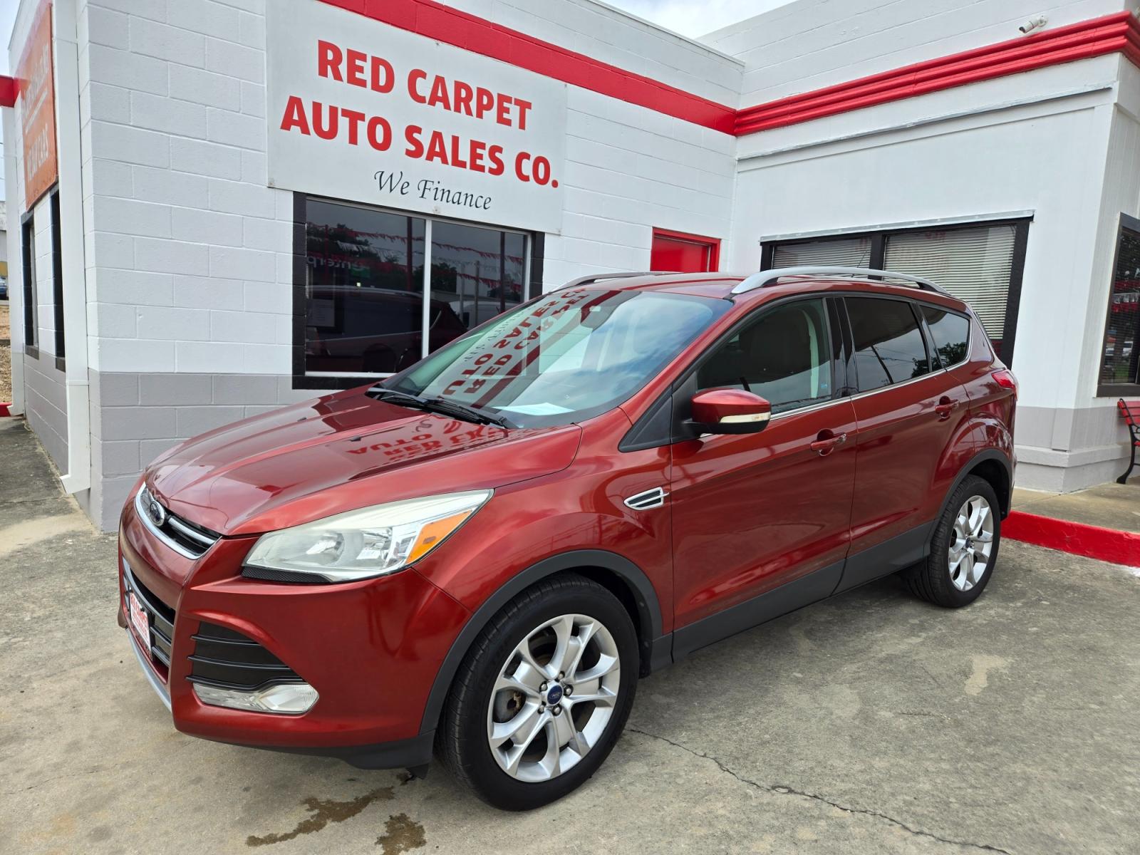 2014 Orange Ford Escape Titanium 4WD (1FMCU9JX7EU) with an 1.6L L4 DOHC 16V engine, 6-Speed Automatic transmission, located at 503 West Court, Seguin, TX, 78155, (830) 379-3373, 29.568621, -97.969803 - Photo #0